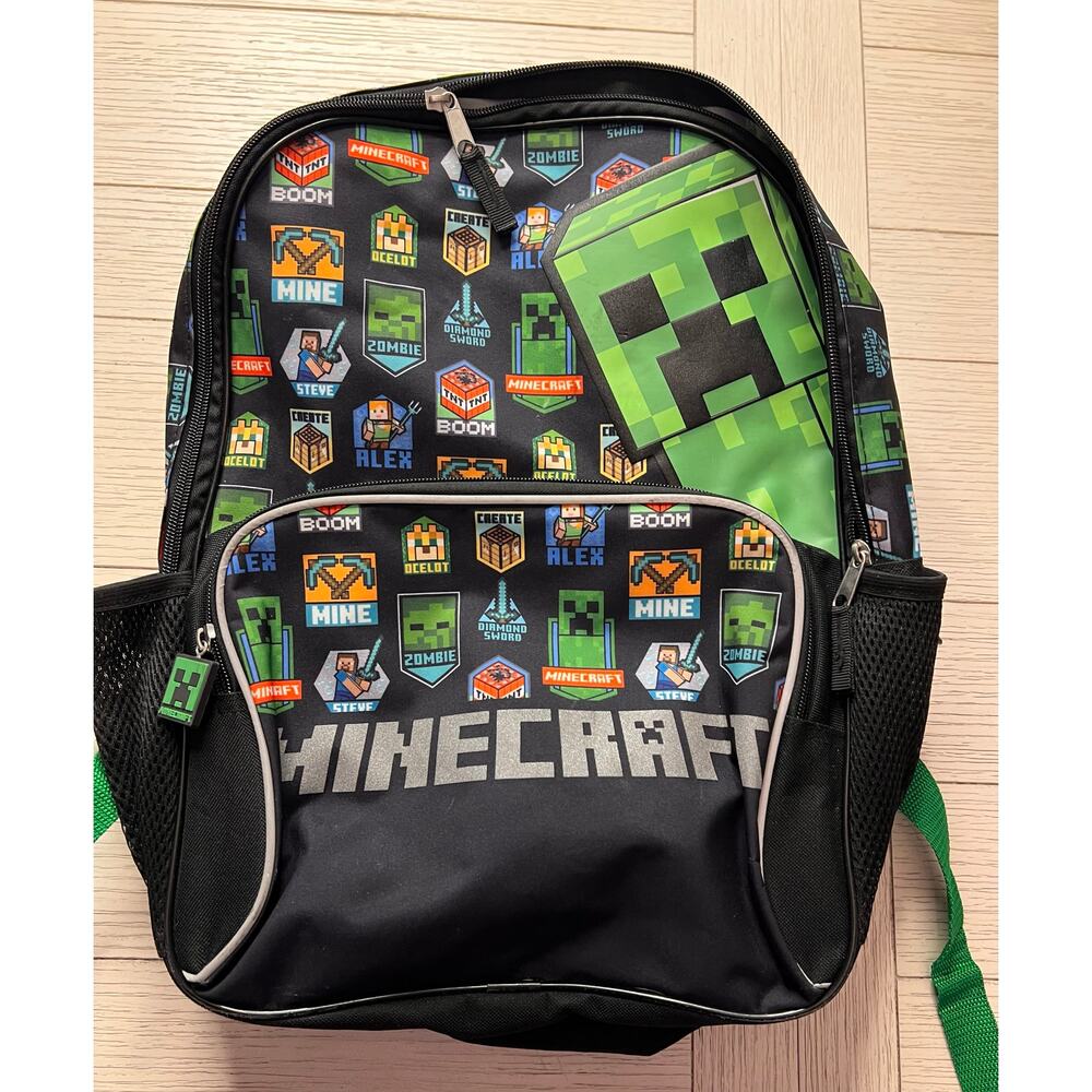 Minecraft backpack w/ 2 zippered sections. Measures 11"x17".